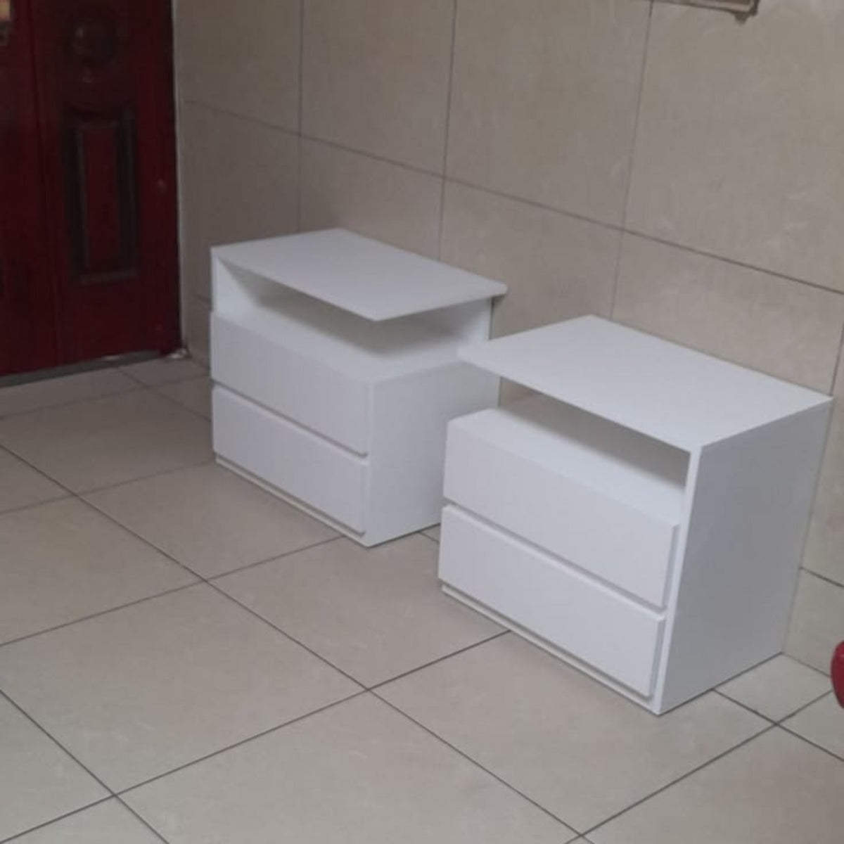 White C Comode two-drawer bedside tables by Tafaseel Home Decor